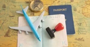 a passport and toy airplane on a map